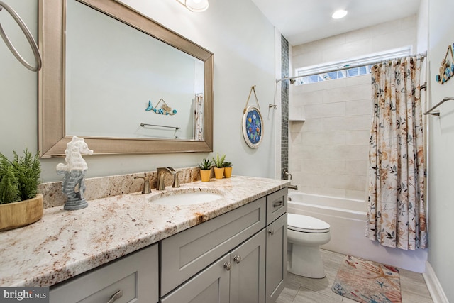 full bathroom featuring vanity, shower / tub combo with curtain, and toilet