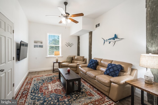 living room featuring ceiling fan and hardwood / wood-style flooring