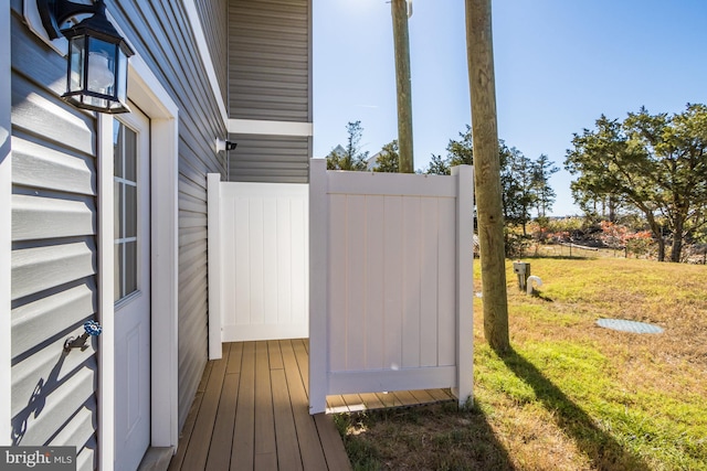 wooden deck featuring a lawn