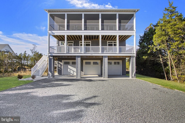 raised beach house featuring a garage