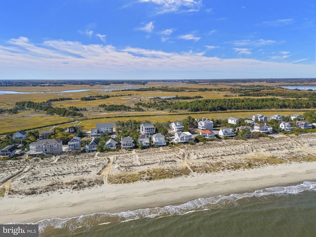 bird's eye view with a water view and a beach view