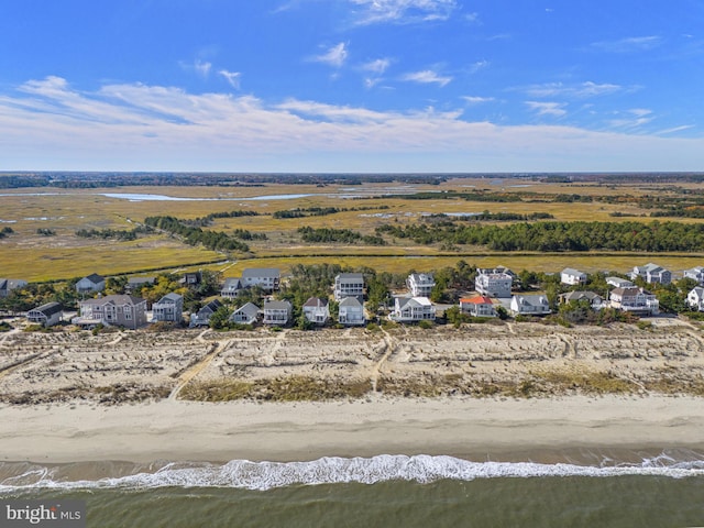 drone / aerial view featuring a water view and a beach view