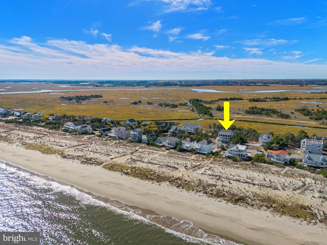 drone / aerial view with a water view and a beach view