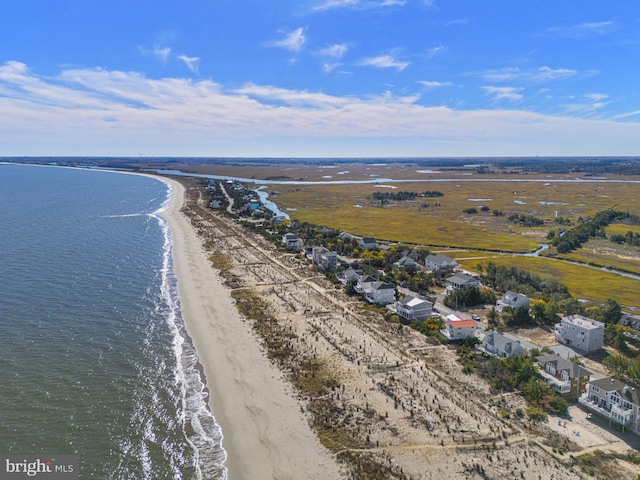 drone / aerial view with a water view and a beach view