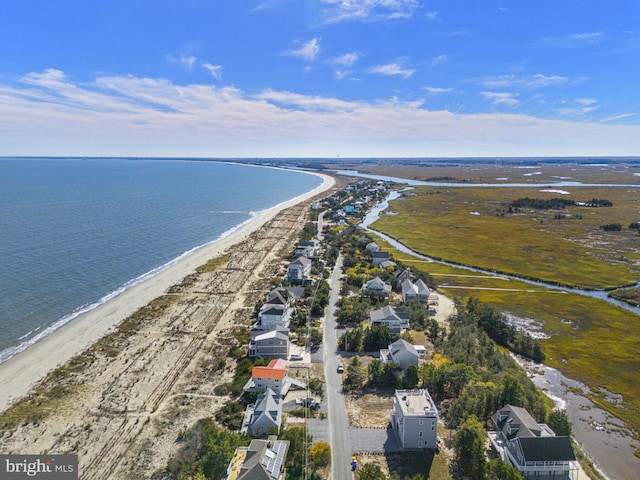 bird's eye view featuring a water view and a beach view