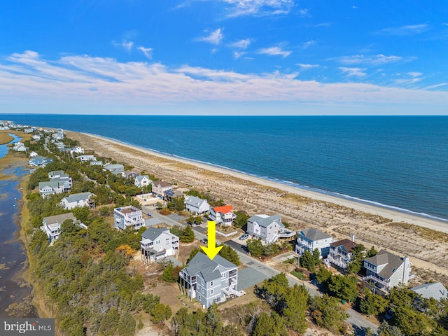 drone / aerial view featuring a water view and a view of the beach