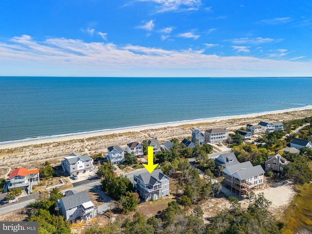 aerial view with a water view and a beach view