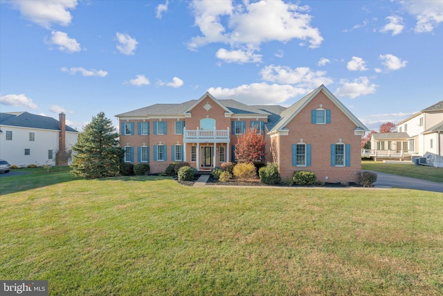 20069 Forest Farm Ln, Ashburn, VA 20147 - view of front facade featuring a balcony, brick siding, and a front lawn