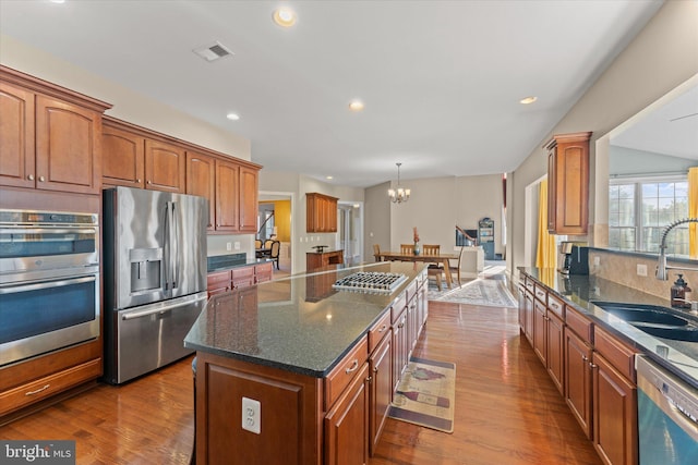 20069 Forest Farm Ln, Ashburn, VA 20147 - kitchen with a center island, a sink, visible vents, appliances with stainless steel finishes, and dark wood-style floors