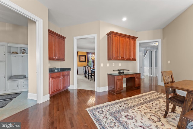 20069 Forest Farm Ln, Ashburn, VA 20147 - kitchen featuring recessed lighting, baseboards, dark wood-style flooring, a sink, and dark countertops