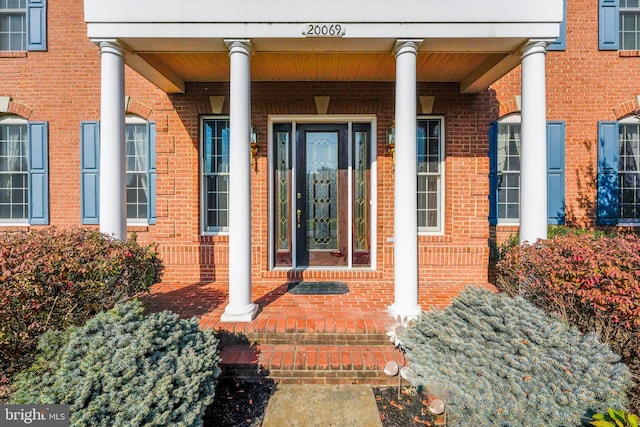 20069 Forest Farm Ln, Ashburn, VA 20147 - doorway to property with brick siding and covered porch