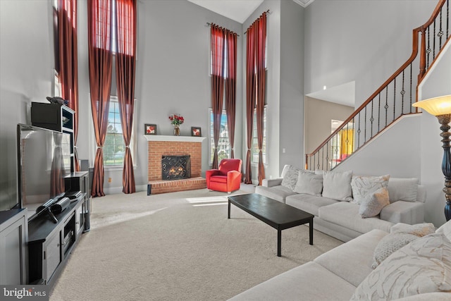 20069 Forest Farm Ln, Ashburn, VA 20147 - carpeted living area featuring stairway, a towering ceiling, and a brick fireplace