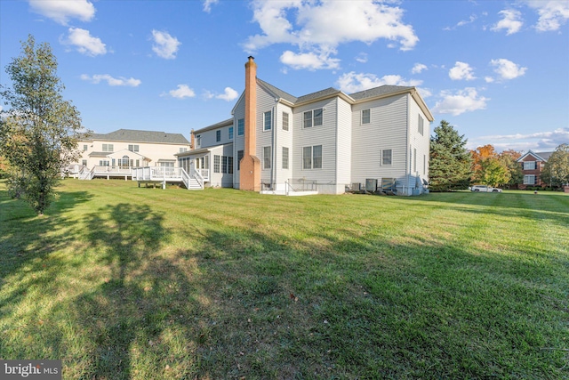 20069 Forest Farm Ln, Ashburn, VA 20147 - rear view of property featuring a yard, a wooden deck, and a chimney