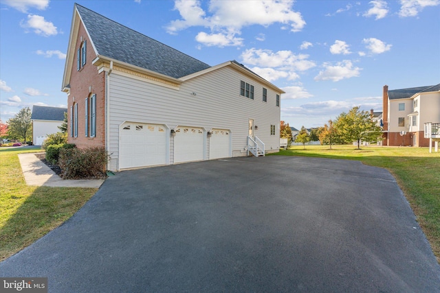 20069 Forest Farm Ln, Ashburn, VA 20147 - view of property exterior with roof with shingles, brick siding, driveway, a yard, and a garage