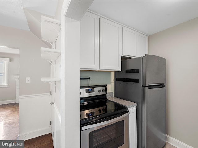 kitchen featuring white cabinetry, stainless steel appliances, and dark wood-type flooring