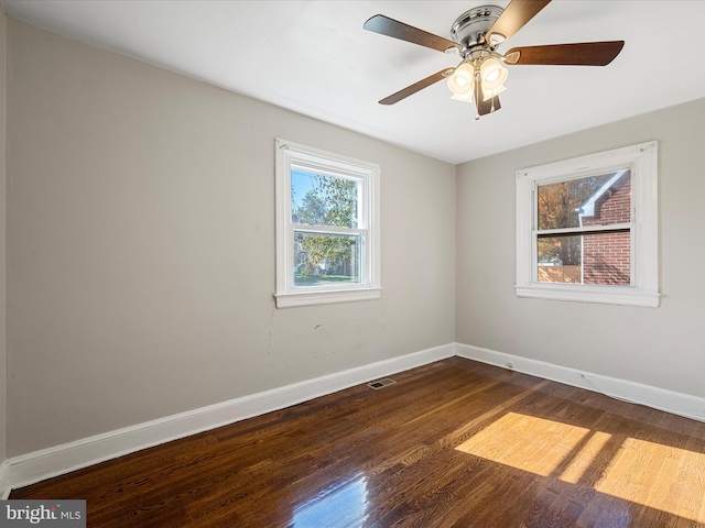 unfurnished room featuring ceiling fan and dark hardwood / wood-style flooring