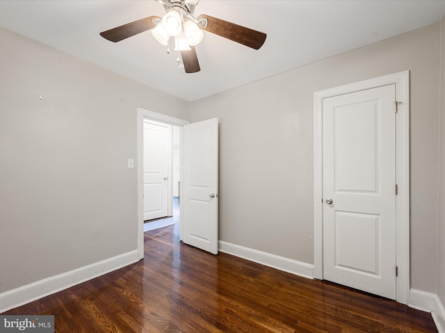 unfurnished bedroom featuring dark hardwood / wood-style flooring and ceiling fan