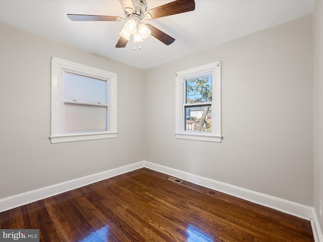 spare room featuring hardwood / wood-style floors and ceiling fan