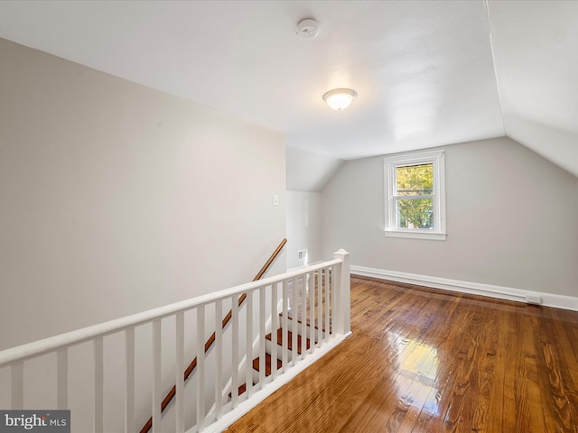 bonus room featuring vaulted ceiling and hardwood / wood-style flooring