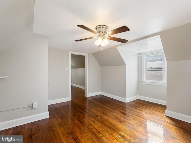 additional living space featuring dark hardwood / wood-style floors, ceiling fan, and vaulted ceiling