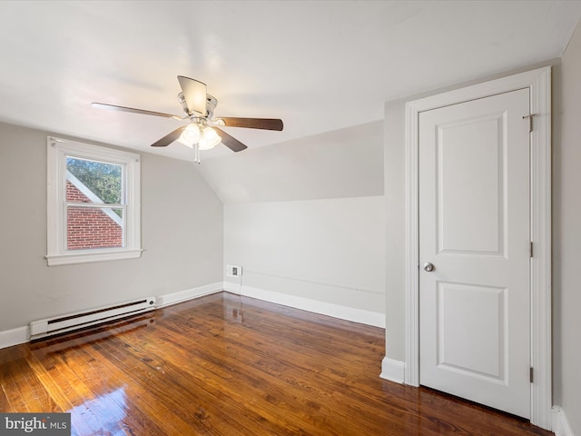 bonus room featuring a baseboard heating unit, ceiling fan, dark wood-type flooring, and vaulted ceiling