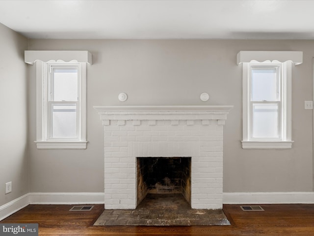 details featuring wood-type flooring and a brick fireplace