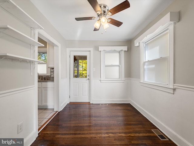 interior space with sink, dark wood-type flooring, and ceiling fan