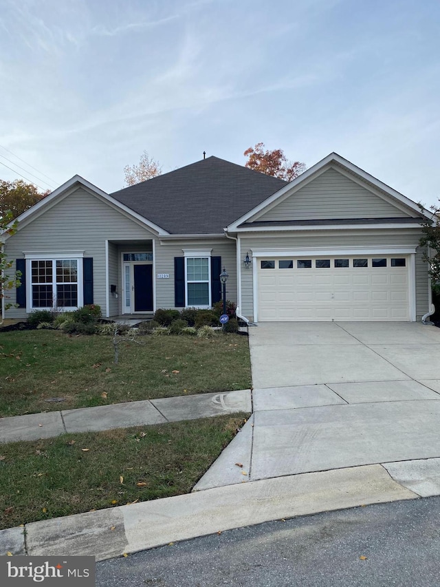 single story home featuring a garage and a front lawn