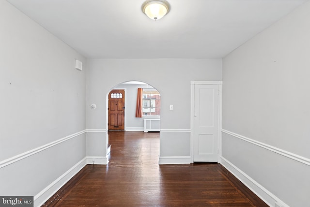 unfurnished room featuring dark wood-type flooring