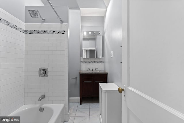 full bathroom featuring vanity, toilet, and tiled shower / bath