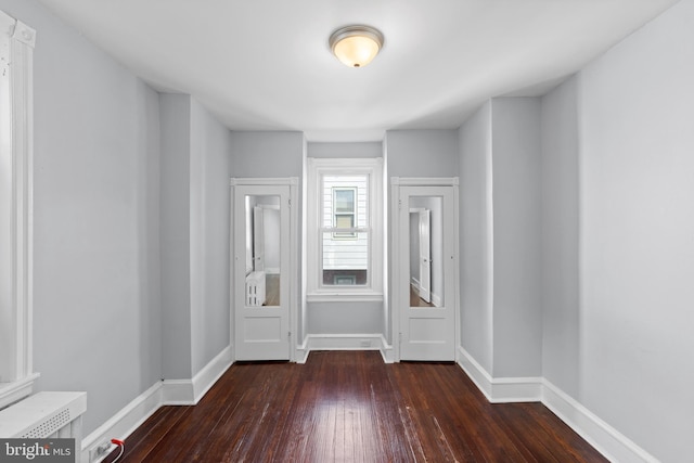 spare room with dark wood-type flooring