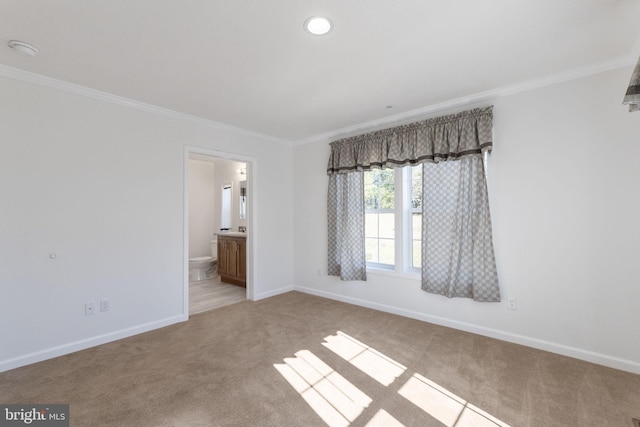 unfurnished room featuring light colored carpet and ornamental molding