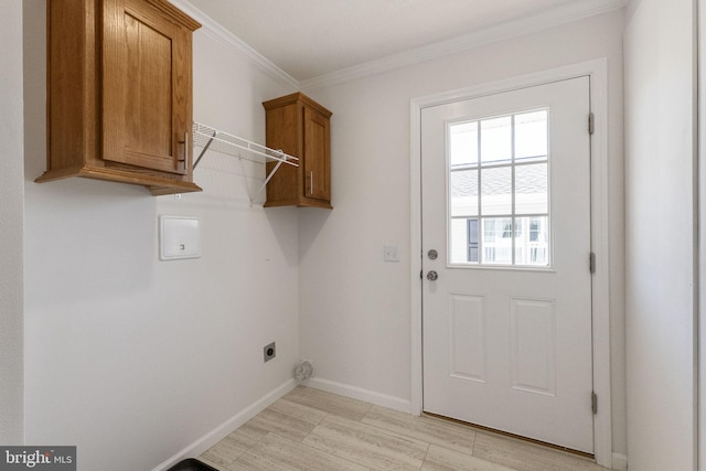 laundry area with cabinets, electric dryer hookup, light wood-type flooring, and ornamental molding