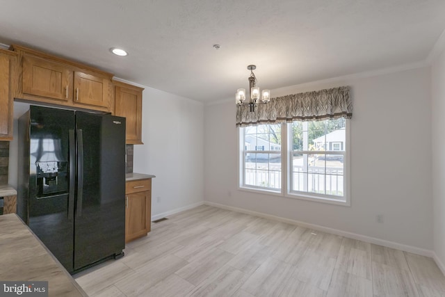 1362 Connecticut Ave, Hagerstown, MD 21740 - kitchen featuring black fridge, brown cabinets, a chandelier, light countertops, and recessed lighting