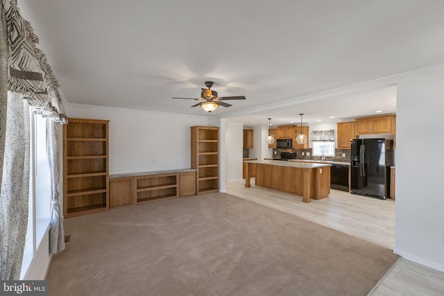 1362 Connecticut Ave, Hagerstown, MD 21740 - unfurnished living room featuring ceiling fan, ornamental molding, light carpet, and baseboards