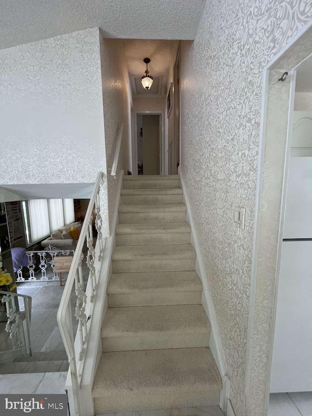 stairway featuring tile patterned floors