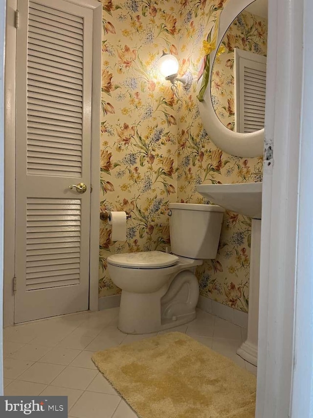 bathroom with toilet and tile patterned flooring