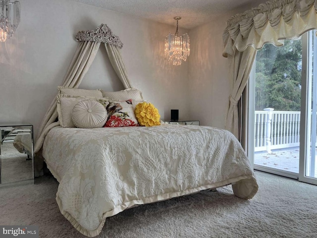 carpeted bedroom with an inviting chandelier, a textured ceiling, and access to exterior