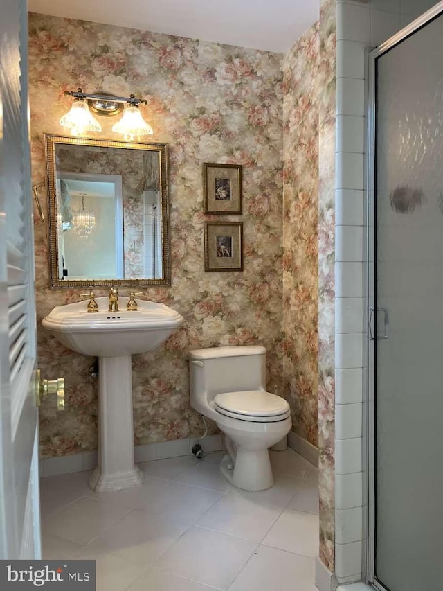 bathroom with toilet, walk in shower, and tile patterned flooring