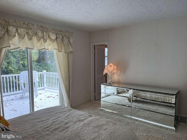 unfurnished bedroom with carpet, access to outside, and a textured ceiling