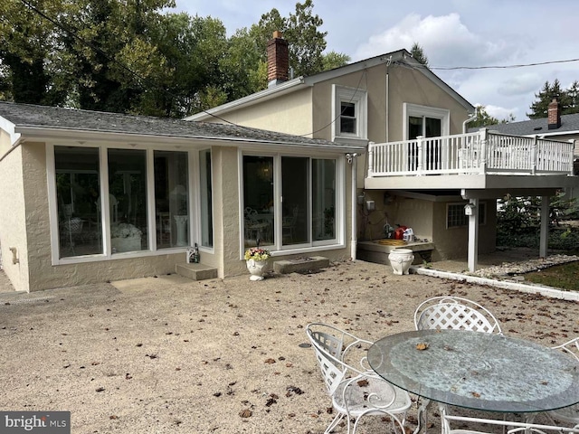 back of property with a wooden deck