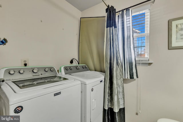 clothes washing area with washer and dryer