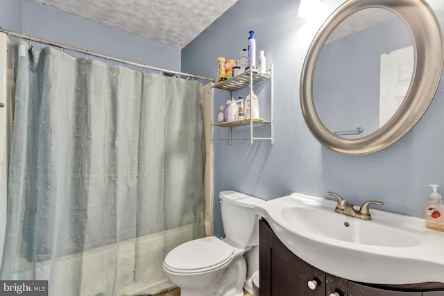 full bathroom featuring shower / bath combo, vanity, a textured ceiling, and toilet