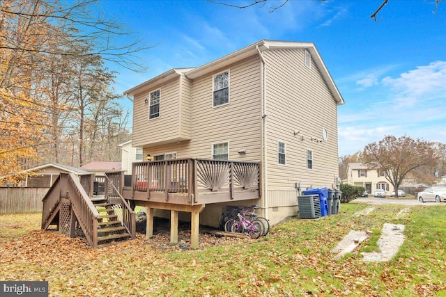 rear view of house featuring cooling unit and a wooden deck