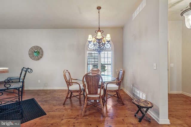 dining room featuring a notable chandelier and hardwood / wood-style flooring