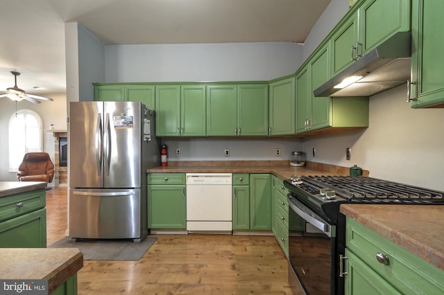 kitchen featuring black range with gas stovetop, white dishwasher, stainless steel fridge, green cabinetry, and light wood-type flooring