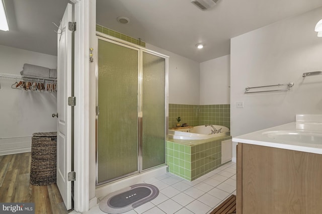 bathroom featuring vanity, shower with separate bathtub, and wood-type flooring