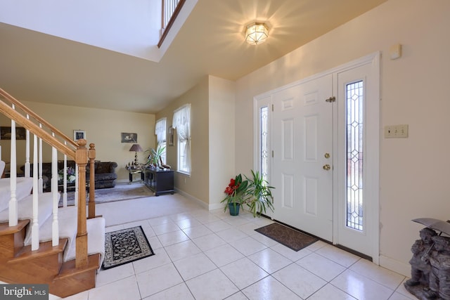 foyer featuring light tile patterned flooring and plenty of natural light