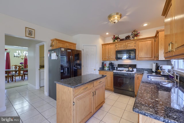 kitchen with dark stone counters, sink, black appliances, a center island, and light tile patterned floors