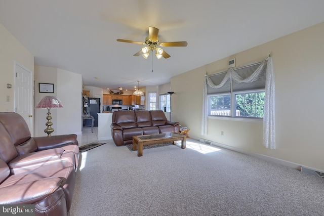 carpeted living room featuring a wealth of natural light and ceiling fan